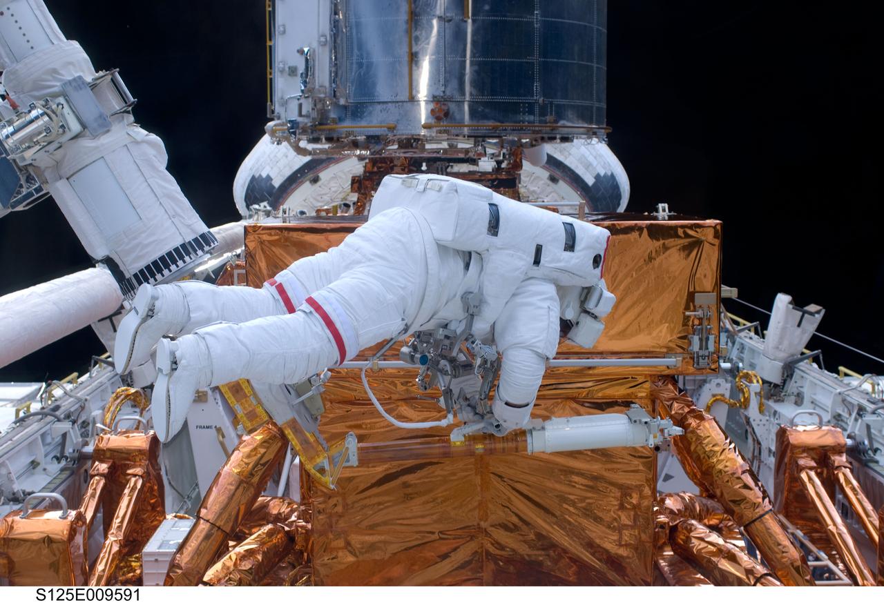 S125-E-009591 (18 May 2009) --- Astronaut John Grunsfeld, STS-125 mission specialist, participates in the mission?s fifth and final session of extravehicular activity (EVA) as work continues to refurbish and upgrade the Hubble Space Telescope. During the seven-hour and two-minute spacewalk, Grunsfeld and astronaut Andrew Feustel (out of frame), mission specialist, installed a battery group replacement, removed and replaced a Fine Guidance Sensor and three thermal blankets (NOBL) protecting Hubble?s electronics.
