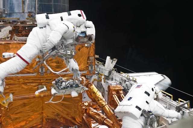 NASA image: STS-125 MS3 Grunsfeld and MS5 Feustel during EVA5