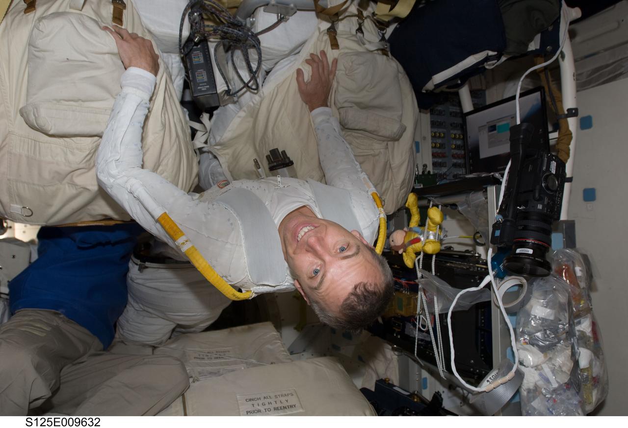 S125-E-009632 (18 May 2009) --- Astronaut Andrew Feustel, STS-125 mission specialist, wearing the liquid cooling and ventilation garment that complements the Extravehicular Mobility Unit (EMU) spacesuit, is picture on the middeck of the Earth-orbiting Space Shuttle Atlantis following the mission?s fifth and final session of extravehicular activity (EVA).