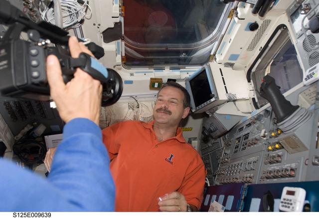 NASA image: STS-125 Crew Members on the Flight Deck during Flight Day 8