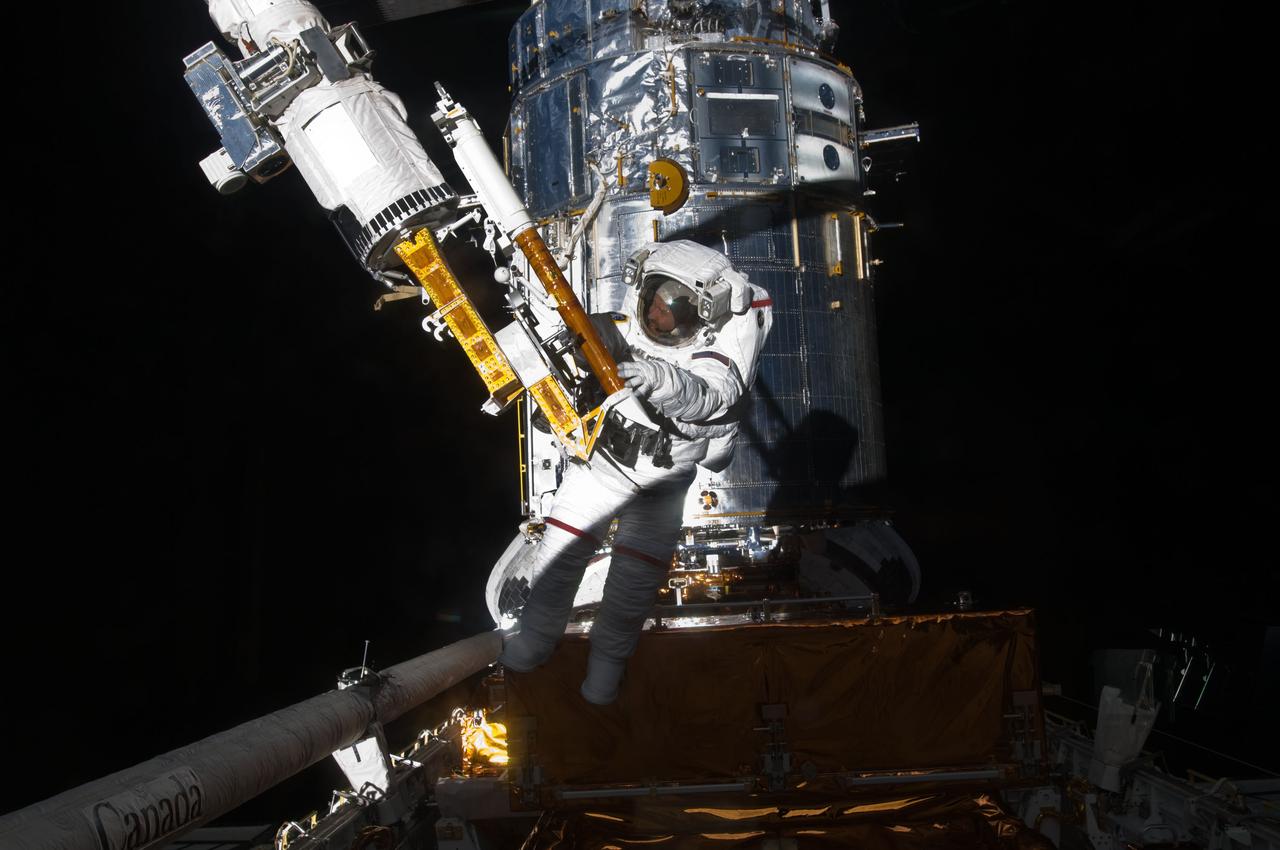 S125-E-009683 (18 May 2009) --- Astronaut John Grunsfeld, STS-125 mission specialist, participates in the mission?s fifth and final session of extravehicular activity (EVA) as work continues to refurbish and upgrade the Hubble Space Telescope. During the seven-hour and two-minute spacewalk, Grunsfeld and astronaut Andrew Feustel (out of frame), mission specialist, installed a battery group replacement, removed and replaced a Fine Guidance Sensor and three thermal blankets (NOBL) protecting Hubble?s electronics.