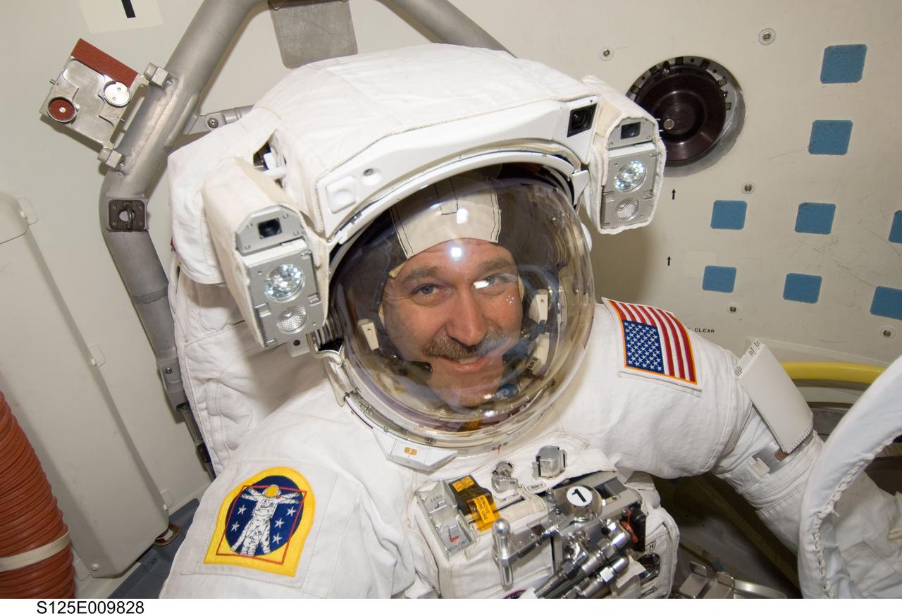 S125-E-009828 (18 May 2009) --- Astronaut John Grunsfeld, STS-125 mission specialist, attired in his Extravehicular Mobility Unit (EMU) spacesuit, is pictured in the Earth-orbiting Space Shuttle Atlantis? airlock as he prepares for the mission?s fifth and final session of extravehicular activity (EVA).
