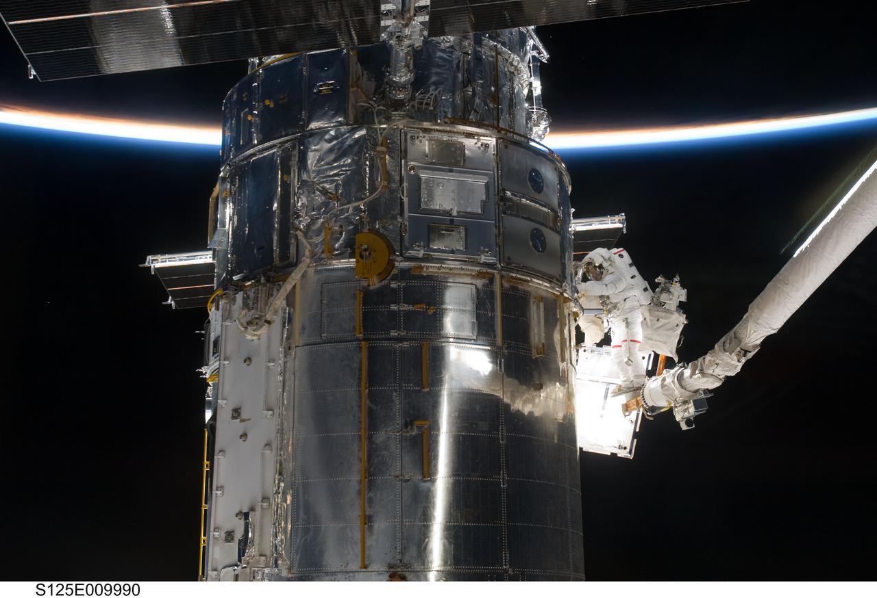 STS-125 MS3 Grunsfeld and MS5 Feustel during EVA5