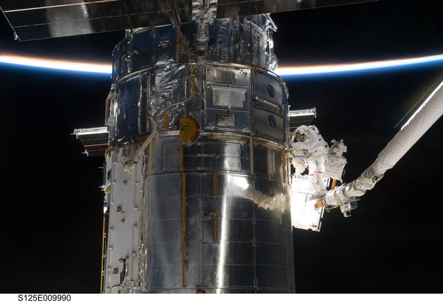 NASA image: STS-125 MS3 Grunsfeld and MS5 Feustel during EVA5