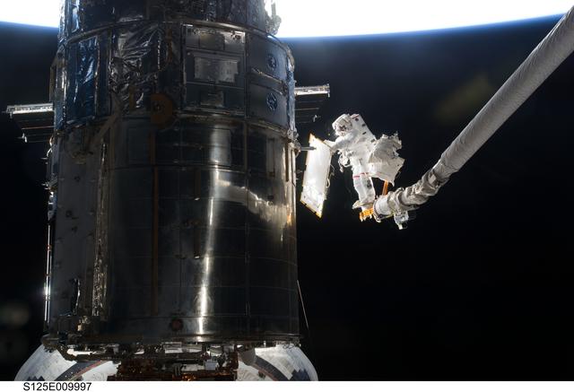 NASA image: STS-125 MS3 Grunsfeld and MS5 Feustel during EVA5