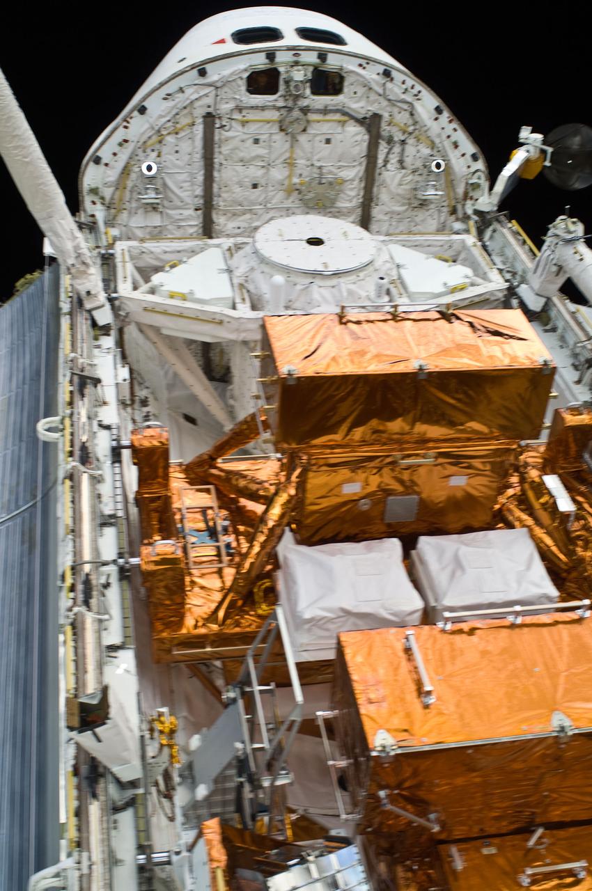 S125-E-010084 (18 May 2009) --- This scene, showing the cabin and cargo bay of the Earth-orbiting Space Shuttle Atlantis was photographed by one of the space walking astronauts during the mission?s fifth and final session of extravehicular activity (EVA) as work continues to refurbish and upgrade the Hubble Space Telescope. Astronaut Megan McArthur, STS-125 mission specialist, at the controls of the remote manipulator system (RMS), can be seen through an aft flight deck window.