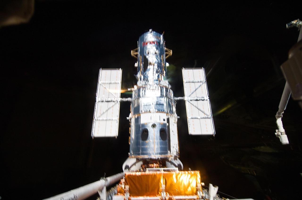 S125-E-010160 (19 May 2009) --- A final look at the Hubble Space Telescope prior to its release following a full week's work. Atlantis' remote manipulator system arm, instrumental in last week's capture and the impending release of the giant orbital observatory, is at the right edge of the frame.