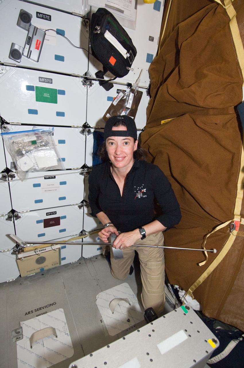 S125-E-011440 (18 May 2009) --- Astronaut Megan McArthur, STS-125 mission specialist, works on the middeck of the Earth-orbiting Space Shuttle Atlantis during flight day eight activities.