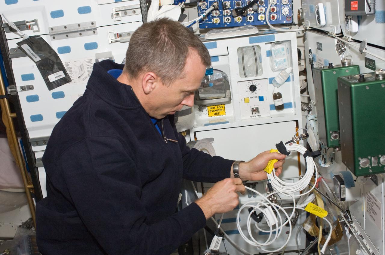 S125-E-012743 (20 May 2009) --- Astronaut Andrew Feustel, STS-125 mission specialist, works on the middeck of the Earth-orbiting Space Shuttle Atlantis during flight day 10 activities.
