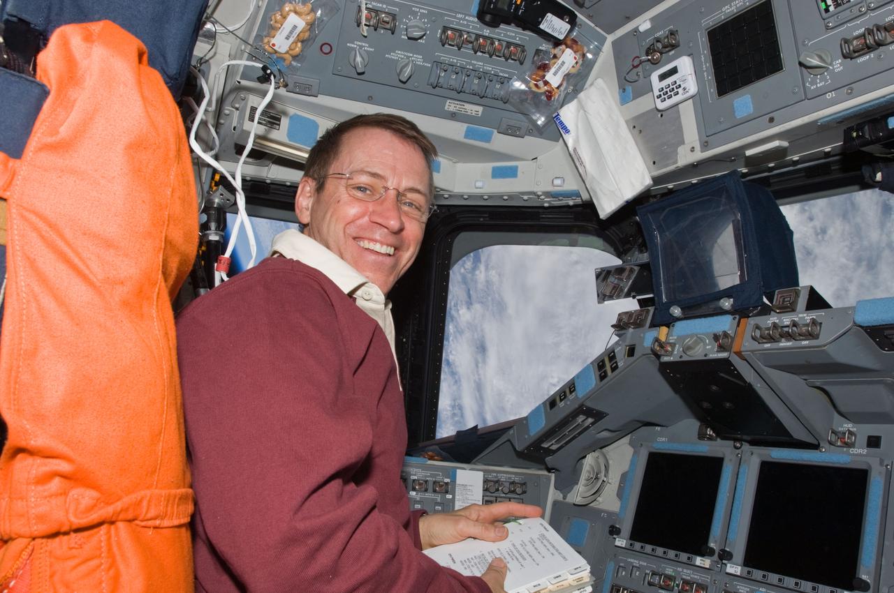 S125-E-013038 (21 May 2009) --- Astronaut Gregory C. Johnson, STS-125 pilot, occupies the commander?s station on the flight deck of the Earth-orbiting Space Shuttle Atlantis during flight day 11 activities.