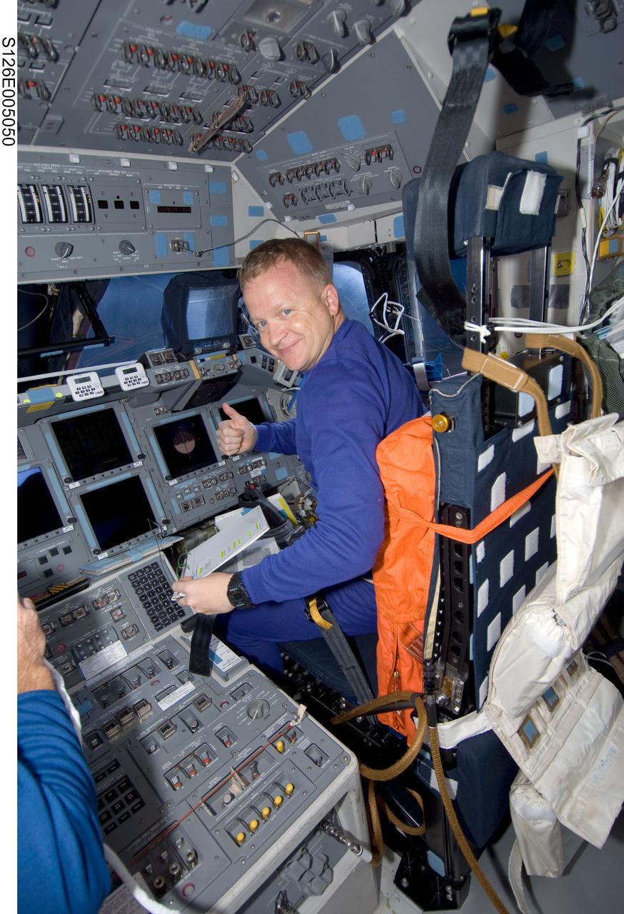 S126-E-005050 (14 Nov. 2008) --- Astronaut Eric Boe, STS-126 pilot, takes a moment for a photo while occupying the pilot's station on the flight deck of Space Shuttle Endeavour during post launch activities.