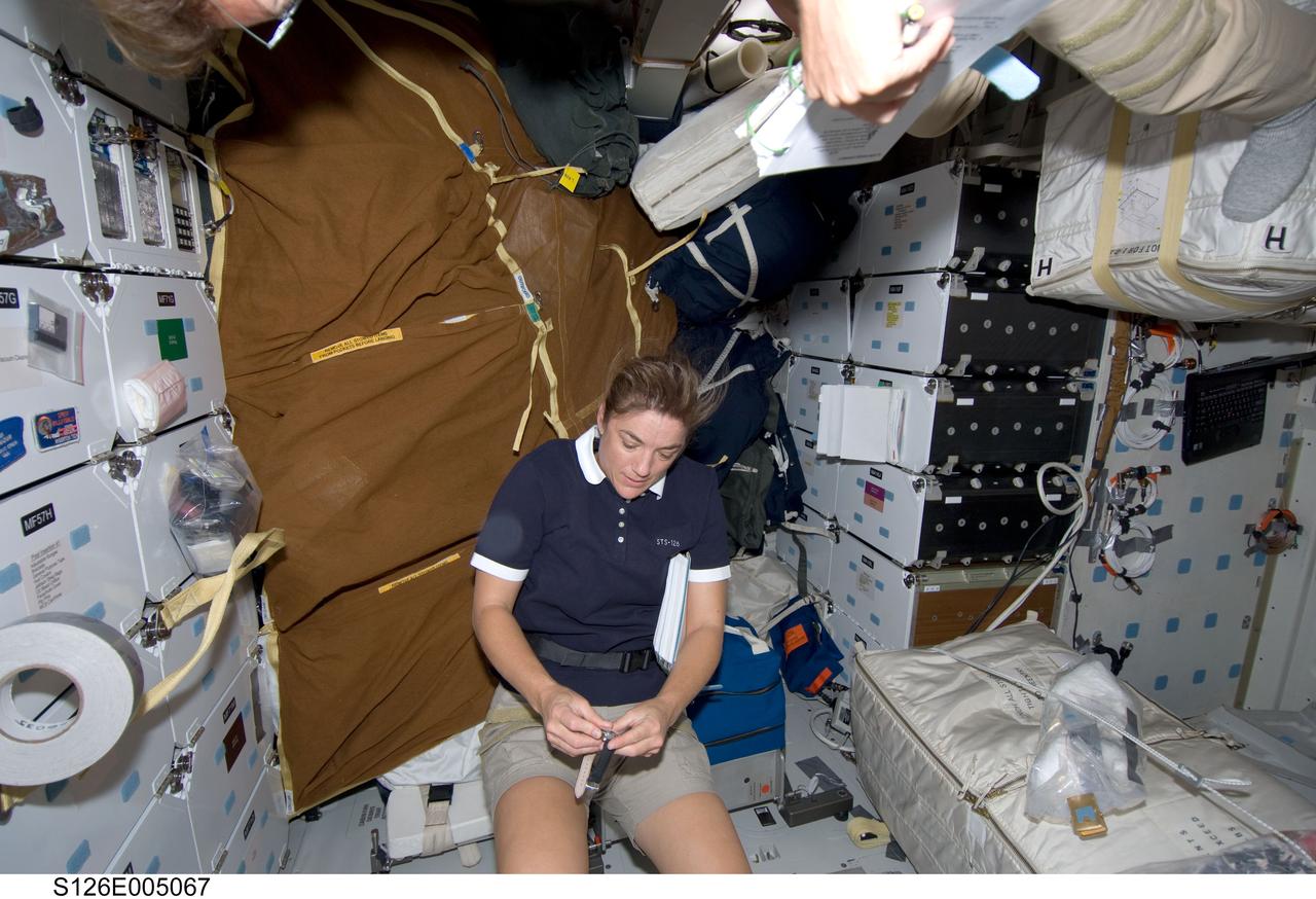 S126-E-005067 (14 Nov. 2008) --- Astronaut Heidemarie Stefanyshyn-Piper, STS-126 mission specialist, works on the middeck of Space Shuttle Endeavour during post launch activities.