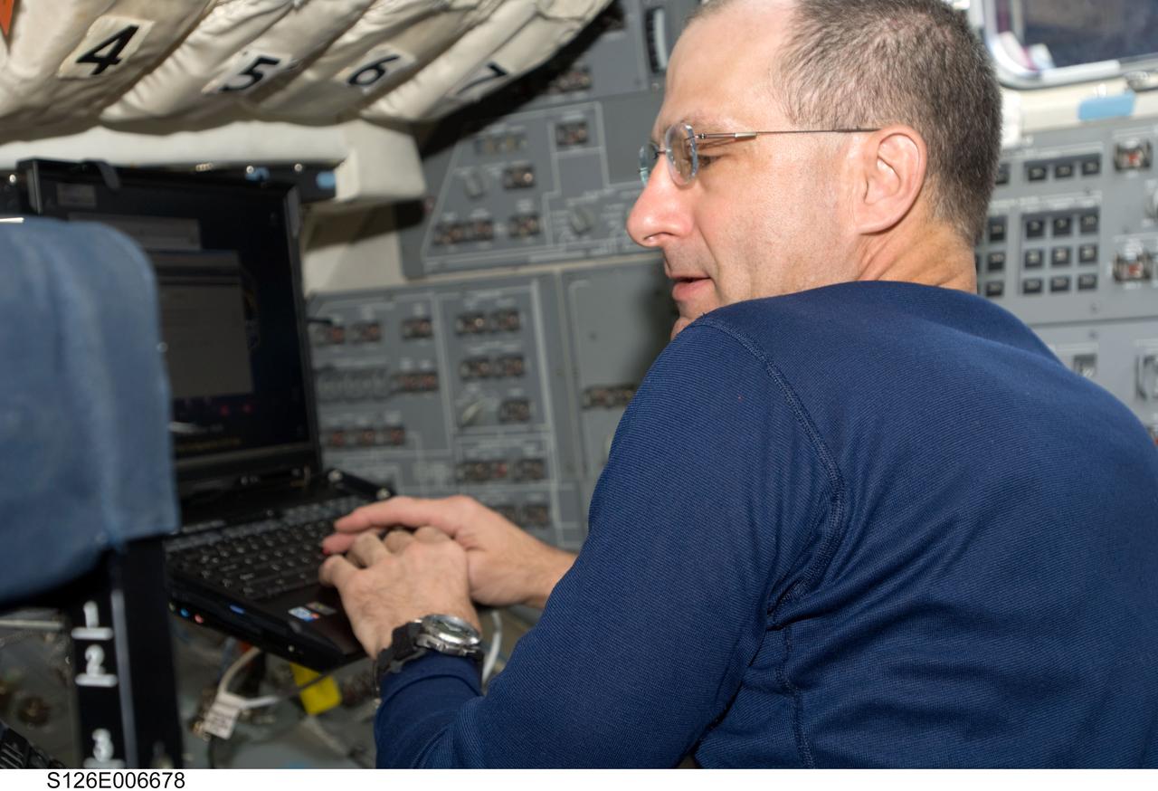 S126-E-006678 (14 Nov. 2008) --- Astronaut Donald Pettit, STS-126 mission specialist, uses a computer on the flight deck of Space Shuttle Endeavour during post launch activities.