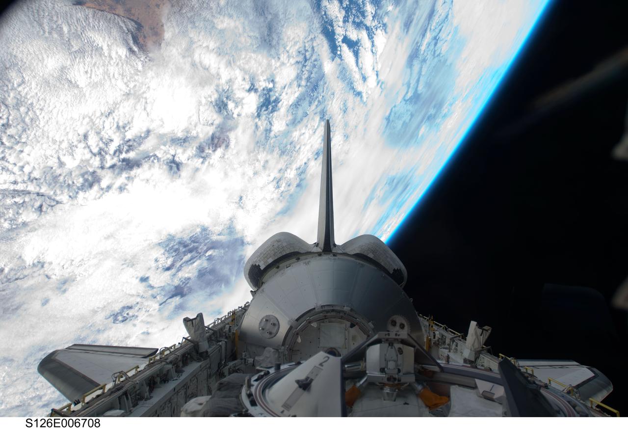 S126-E-006708 (15 Nov. 2008) --- Backdropped by a colorful Earth and the blackness of space, the Leonardo Multi-Purpose Logistics Module visible in Space Shuttle Endeavour's payload bay, vertical stabilizer, orbital maneuvering system (OMS) pods and docking mechanism are featured in this image photographed by a STS-126 crewmember.