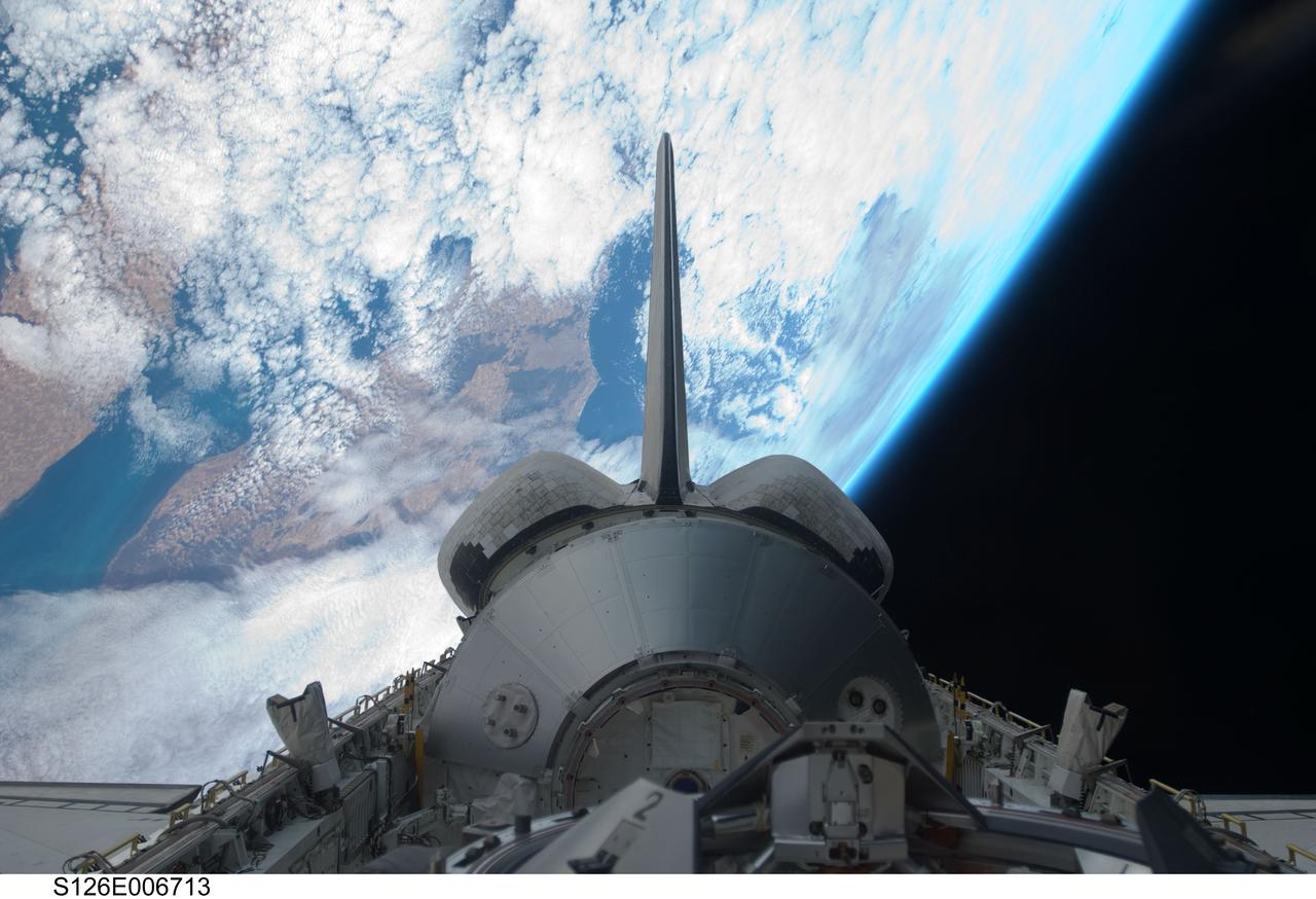 S126-E-006713 (15 Nov. 2008) --- Backdropped by a colorful Earth and the blackness of space, the Leonardo Multi-Purpose Logistics Module visible in Space Shuttle Endeavour's payload bay, vertical stabilizer, orbital maneuvering system (OMS) pods and docking mechanism are featured in this image photographed by a STS-126 crewmember.