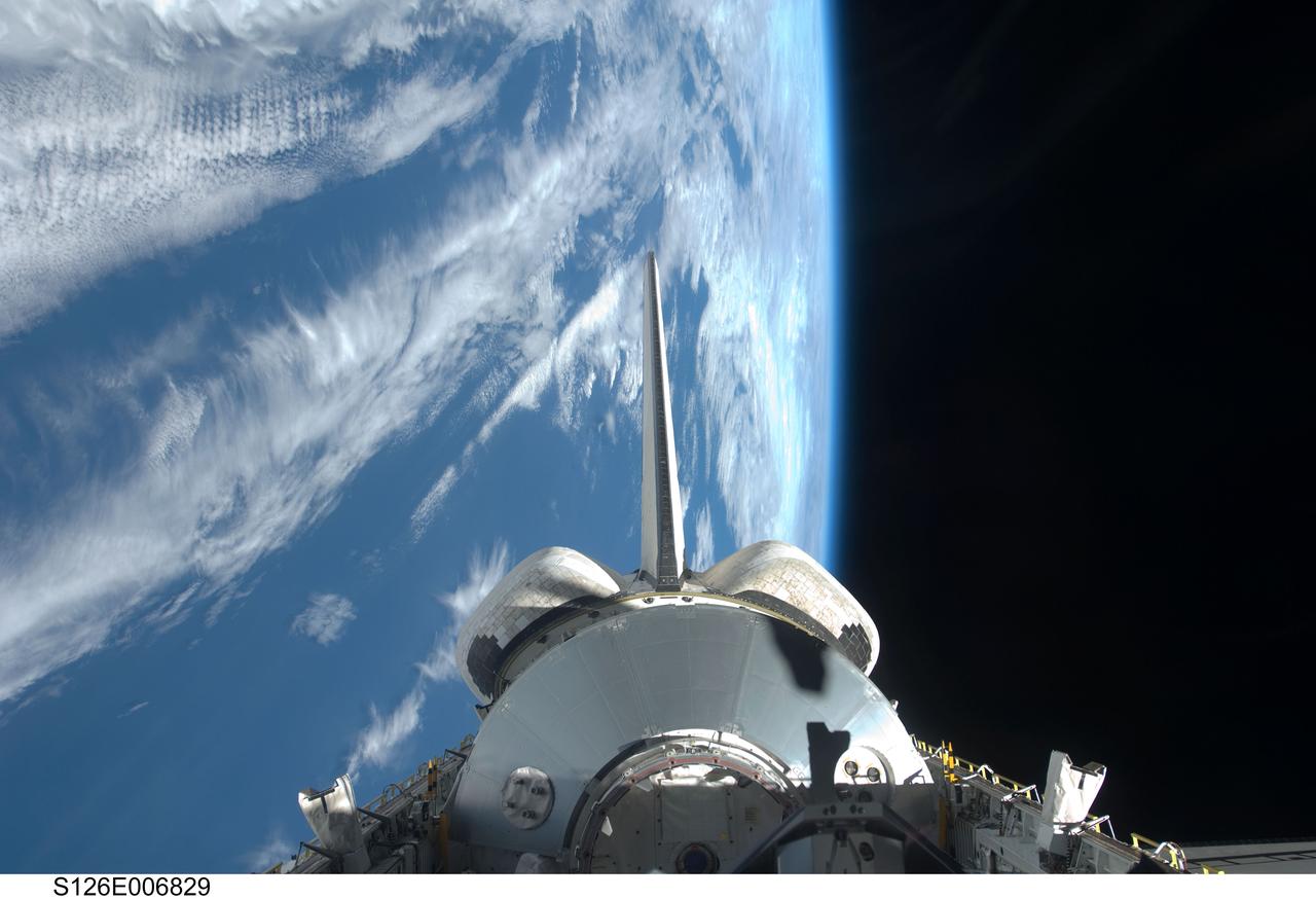 S126-E-006829 (15 Nov. 2008) --- Backdropped by a blue and white Earth and the blackness of space, the Leonardo Multi-Purpose Logistics Module visible in Space Shuttle Endeavour's payload bay, vertical stabilizer and orbital maneuvering system (OMS) pods are featured in this image photographed by a STS-126 crewmember.