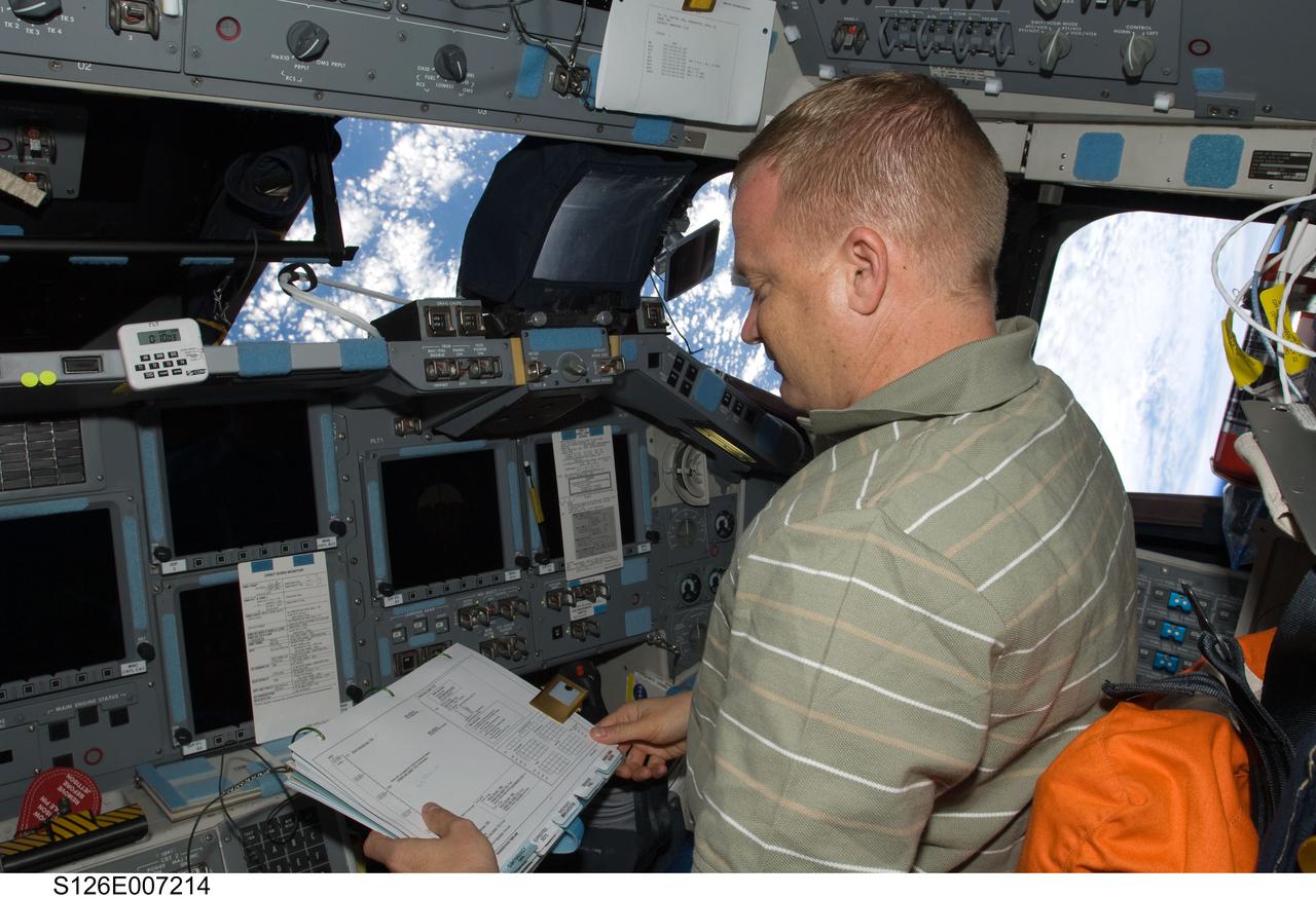 S126-E-007214 (16 Nov. 2008) --- Astronaut Eric Boe, STS-126 pilot, occupies the pilot's station on the forward flight deck of Space Shuttle Endeavour during rendezvous and docking operations with the International Space Station.
