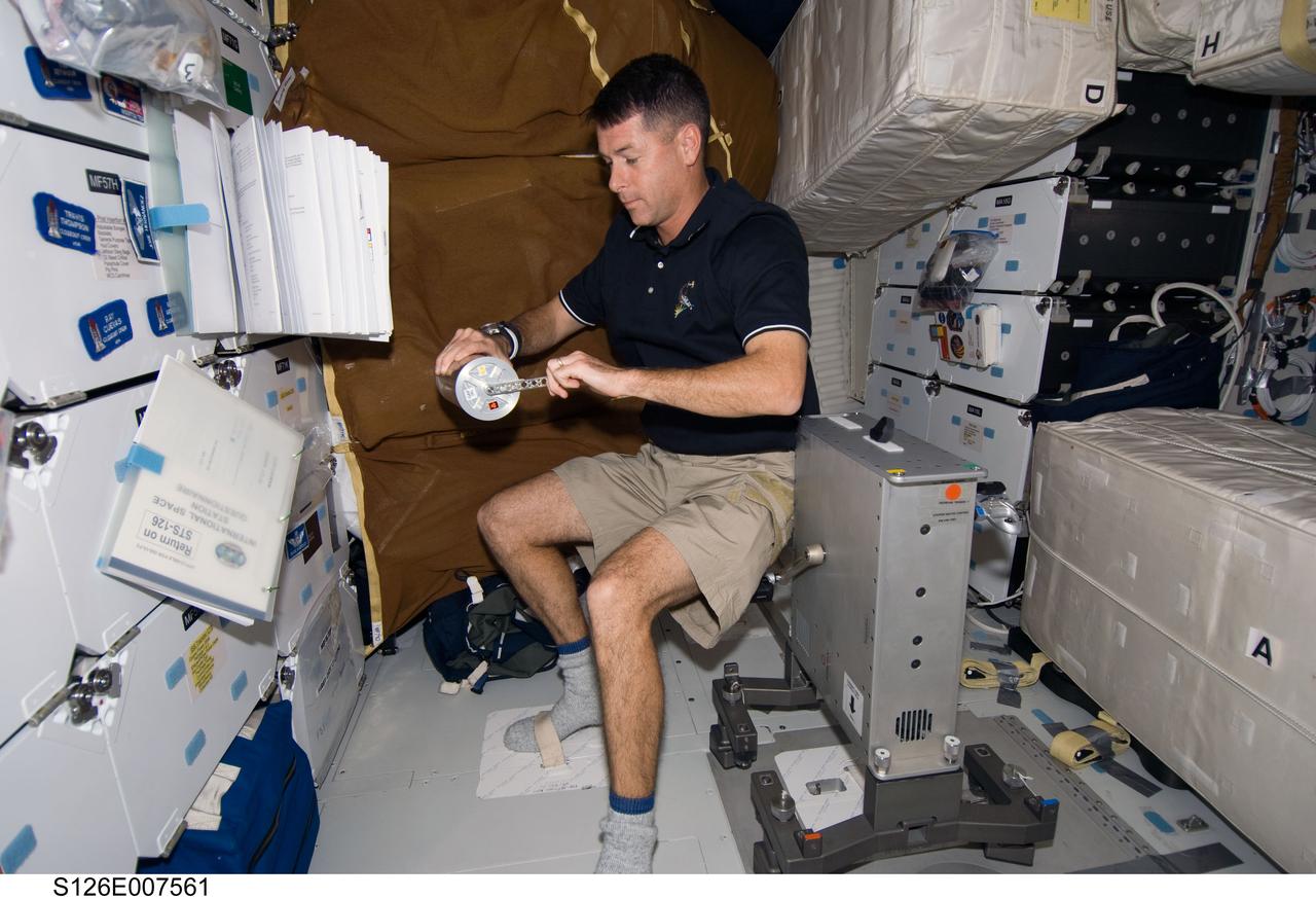 S126-E-007561 (16 Nov. 2008) --- Astronaut Shane Kimbrough, STS-126 mission specialist, works with the National Lab Pathfinder-Vaccine Group Activation Pack on the middeck of Space Shuttle Endeavour while docked with the International Space Station.