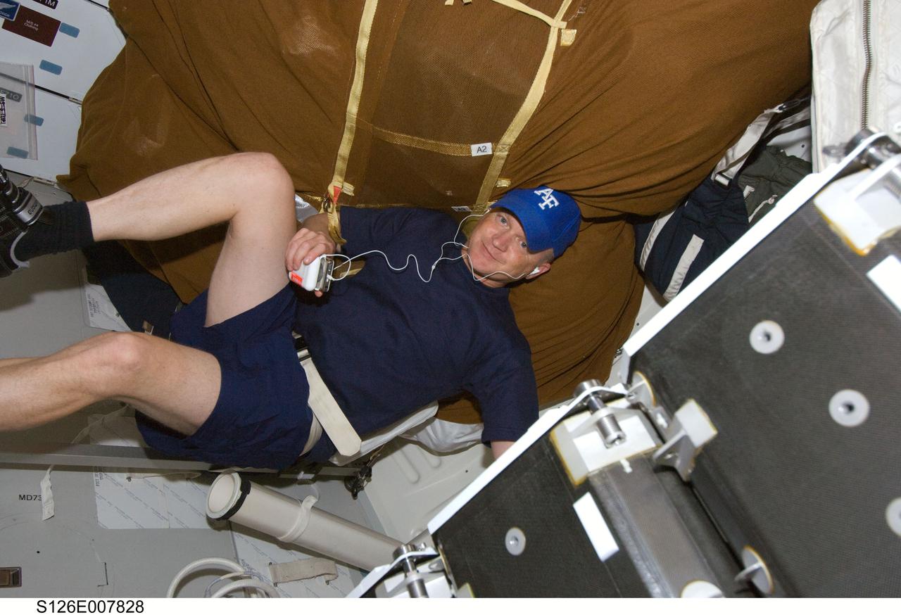 S126-E-007828 (16 Nov. 2008) --- Astronaut Eric Boe, STS-126 pilot, exercises on the bicycle ergometer on the middeck of Space Shuttle Endeavour.
