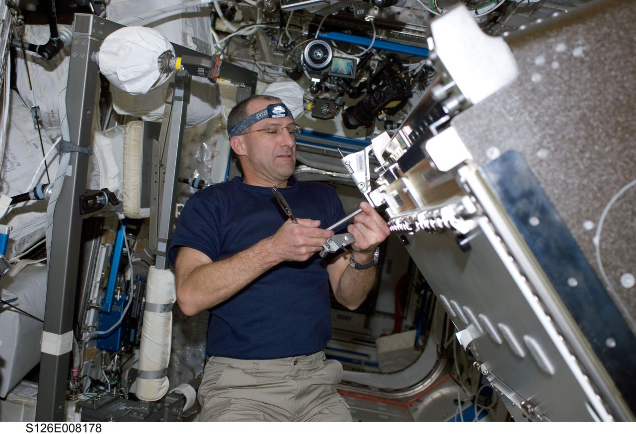 S126-E-008178 (18 Nov. 2008) --- Astronaut Donald Pettit, STS-126 mission specialist, installs the Combustion Integrated Rack (CIR) in the Destiny laboratory of the International Space Station while Space Shuttle Endeavour is docked with the station.