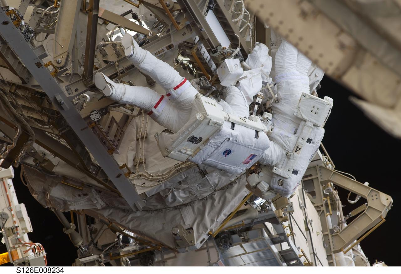 S126-E-008234 (18 Nov. 2008) --- Astronauts Heidemarie Stefanyshyn-Piper (left) and Steve Bowen, both STS-126 mission specialists, participate in the mission's first session of extravehicular activity (EVA) as construction and maintenance continue on the International Space Station. During the six-hour, 52-minute spacewalk, Piper and Bowen worked to clean and lubricate part of the station's starboard Solar Alpha Rotary Joints (SARJ) and to remove two of SARJ's 12 trundle bearing assemblies. The spacewalkers also removed a depleted nitrogen tank from a stowage platform on the outside of the complex and moved it into Endeavour's cargo bay. They also moved a flex hose rotary coupler from the shuttle to the station stowage platform, as well as removing some insulation blankets from the common berthing mechanism on the Kibo laboratory.