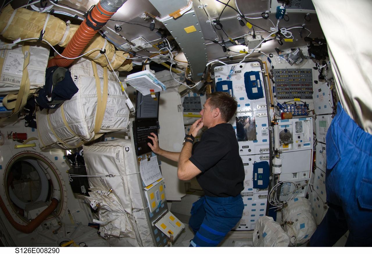 S126-E-008290 (19 Nov. 2008) --- Astronaut Chris Ferguson, STS-126 commander, uses a computer on the middeck of Space Shuttle Endeavour while docked with the International Space Station.