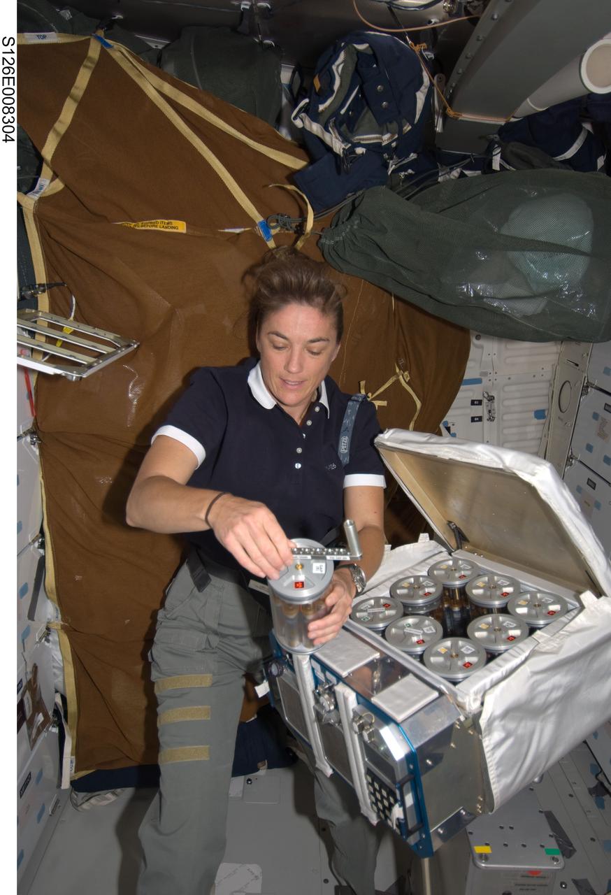 S126-E-008304 (19 Nov. 2008) --- Astronaut Heidemarie Stefanyshyn-Piper, STS-126 mission specialist, works with Group Activation Packs (GAP) on the middeck of Space Shuttle Endeavour while docked with the International Space Station.