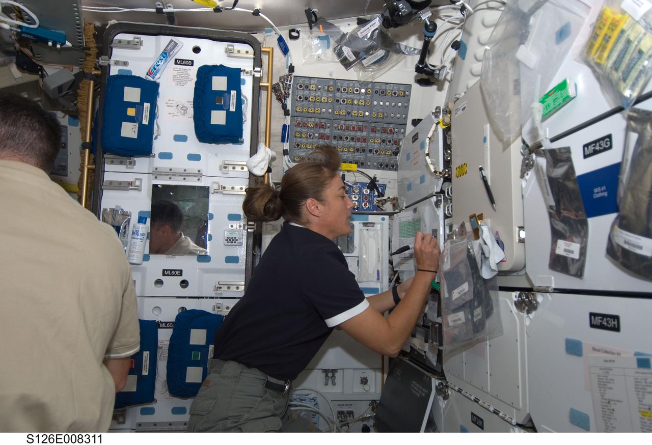 S126-E-008311 (19 Nov. 2008) --- Astronaut Heidemarie Stefanyshyn-Piper, STS-126 mission specialist, makes notations on the middeck of Space Shuttle Endeavour while docked with the International Space Station.