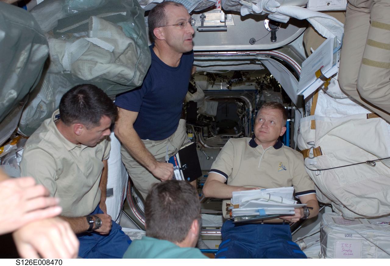S126-E-008470 (19 Nov. 2008) --- STS-126 crewmembers in the Unity node of the International Space Station are pictured during flight day six activities while Space Shuttle Endeavour remains docked with the station. Pictured from the bottom (clockwise) are astronauts Steve Bowen, Shane Kimbrough, Donald Pettit, all mission specialists; and Eric Boe, pilot.