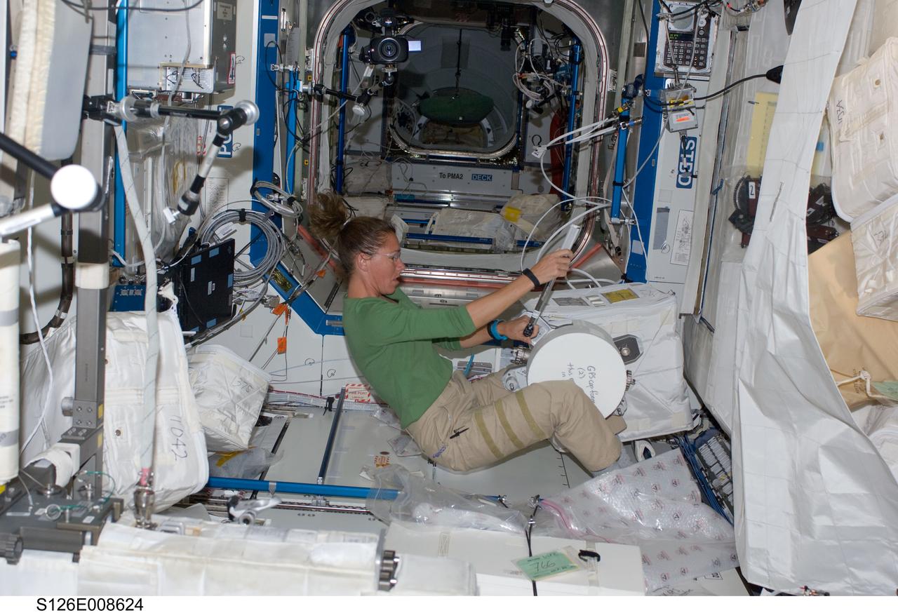 S126-E-008624 (20 Nov. 2008) --- Astronaut Sandra Magnus, Expedition 18 flight engineer, assembles the GPS antenna in the Destiny laboratory of the International Space Station while Space Shuttle Endeavour (STS-126) remains docked with the station. The GPS antenna is scheduled be installed on the Kibo laboratory during the mission's fourth session of extravehicular activity (EVA).