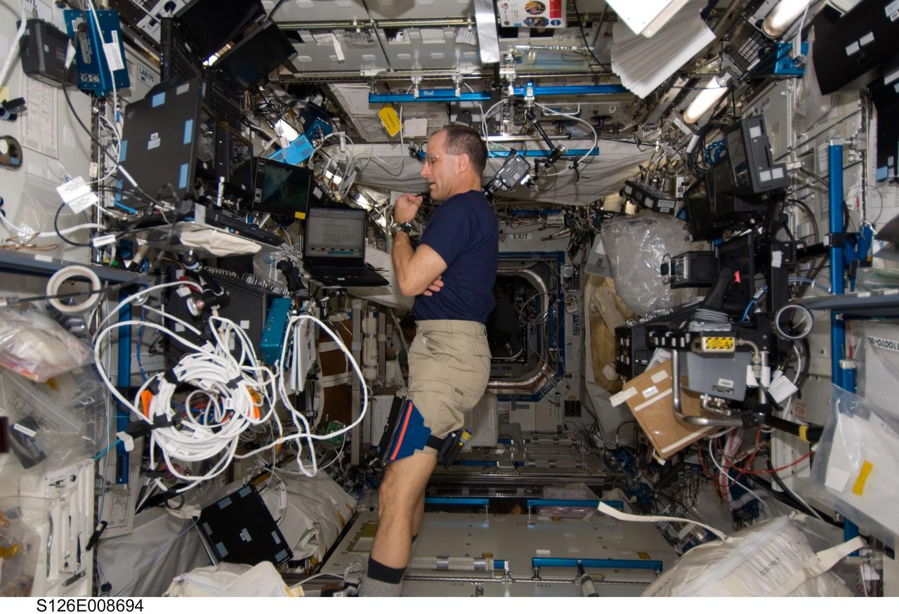 S126-E-008694 (20 Nov. 2008) --- Astronaut Donald Pettit, STS-126 mission specialist, monitors data at the Canadarm2 workstation in the Destiny laboratory of the International Space Station while Space Shuttle Endeavour remains docked with the station.