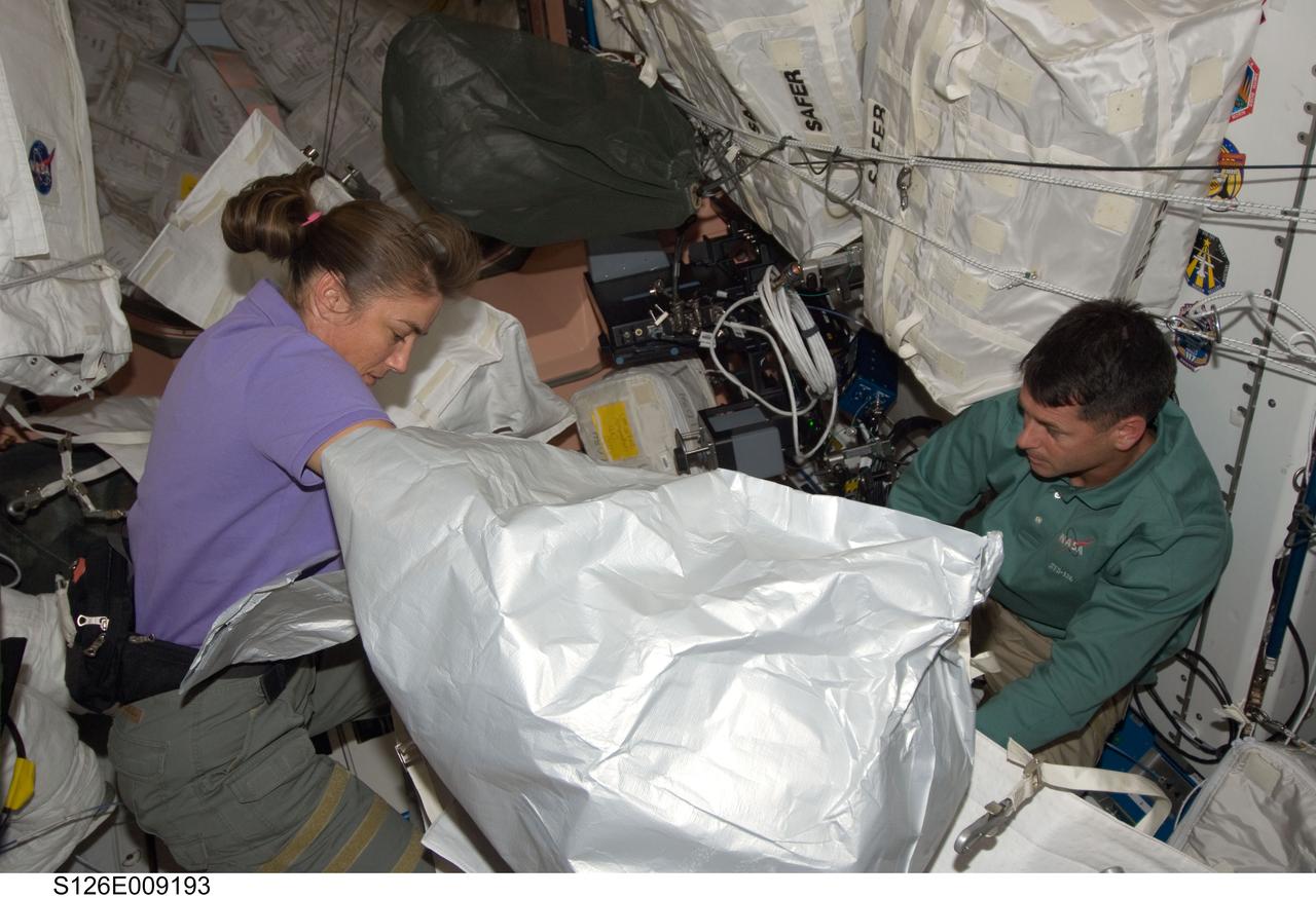 S126-E-009193 (23 Nov. 2008) --- Astronauts Heidemarie Stefanyshyn-Piper and Shane Kimbrough, both STS-126 mission specialists, work in the Unity node of the International Space Station while Space Shuttle Endeavour remains docked with the station.