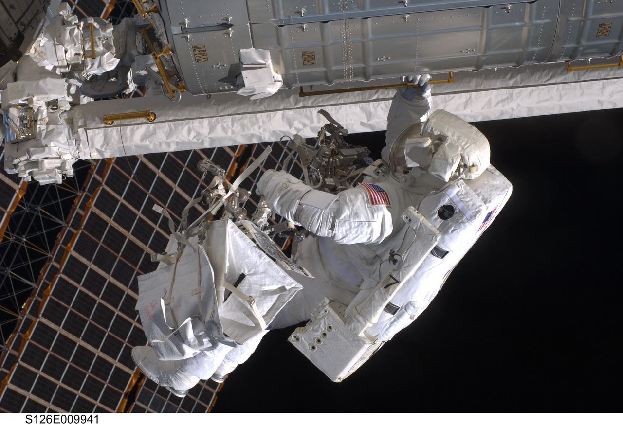 S126-E-009941 (24 Nov. 2008) --- Astronaut Steve Bowen, STS-126 mission specialist, participates in the mission's fourth and final scheduled session of extravehicular activity (EVA) as construction and maintenance continue on the International Space Station. During the six-hour, seven-minute spacewalk, Bowen and astronaut Shane Kimbrough (out of frame), mission specialist, completed the lubrication of the port Solar Alpha Rotary Joints (SARJ) as well as other station assembly tasks. Bowen returned to the starboard SARJ to install the final trundle bearing assembly, retracted a berthing mechanism latch on the Japanese Kibo Laboratory and reinstalled its thermal cover. Bowen also installed a video camera on the Port 1 truss and attached a Global Positioning System antenna on the Japanese Experiment Module Pressurized Section.