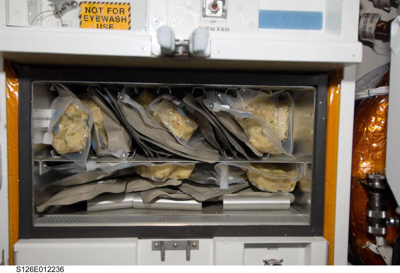 S126-E-12236 (27 Nov. 2008) --- Not far away from this close-up scene of the galley on the Space Shuttle Endeavour were nine astronauts and a cosmonaut eager to share a Thanksgiving meal to top off almost two weeks of joint activities, including an involved home improvement project on the  International Space Station.  Unlike most of their families and friends on Earth, who probably went through pains to prepare elaborate meals for this festive occasion, the STS-126 and Expedition 18 crewmembers merely needed add water to these prepared packets