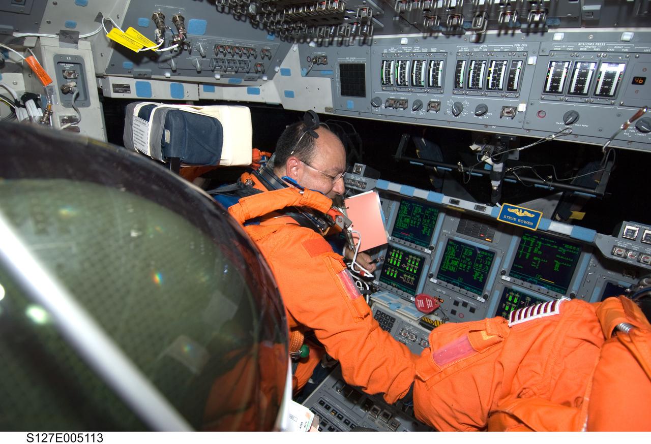 S127-E-005113 (15 July 2009) --- Astronaut Mark Polansky, STS-127 commander, attired in his shuttle launch and entry suit, is pictured at the commander?s station on the flight deck of Space Shuttle Endeavour during postlaunch activities.
