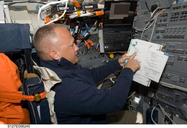 NASA image: Hurley looks at crew procedures in the aft FD on Space Shuttle Endeavour during the STS-127 Mission