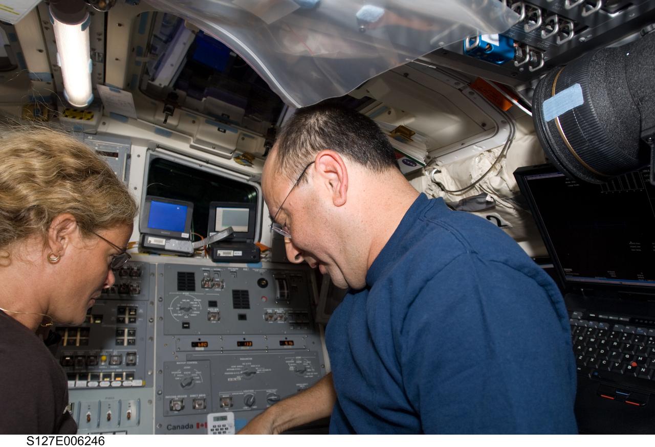 S127-E-006246 (16 July 2009) --- NASA astronaut Mark Polansky, STS-127 commander; and Canadian Space Agency astronaut Julie Payette, mission specialist, are pictured on the aft flight deck of Space Shuttle Endeavour during flight day two activities.