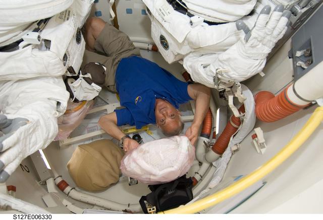 NASA image: Wolf floats upside down in the Shuttle A/L on the Space Shuttle Endeavour during the STS-127 Mission