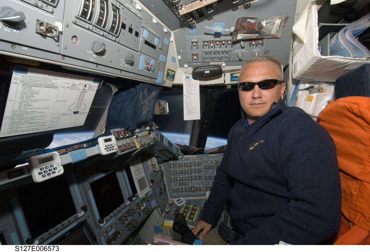 S127-E-006573 (17 July 2009) --- Astronaut Doug Hurley is at the pilot station on Endeavour's flight deck during rendezvous and docking activities between space shuttle and the the International Space Station. Later the STS-127 crew docked the shuttle with the orbital outpost and ingressed it, bringing the population of the ISS to a record 13 people for the time being.