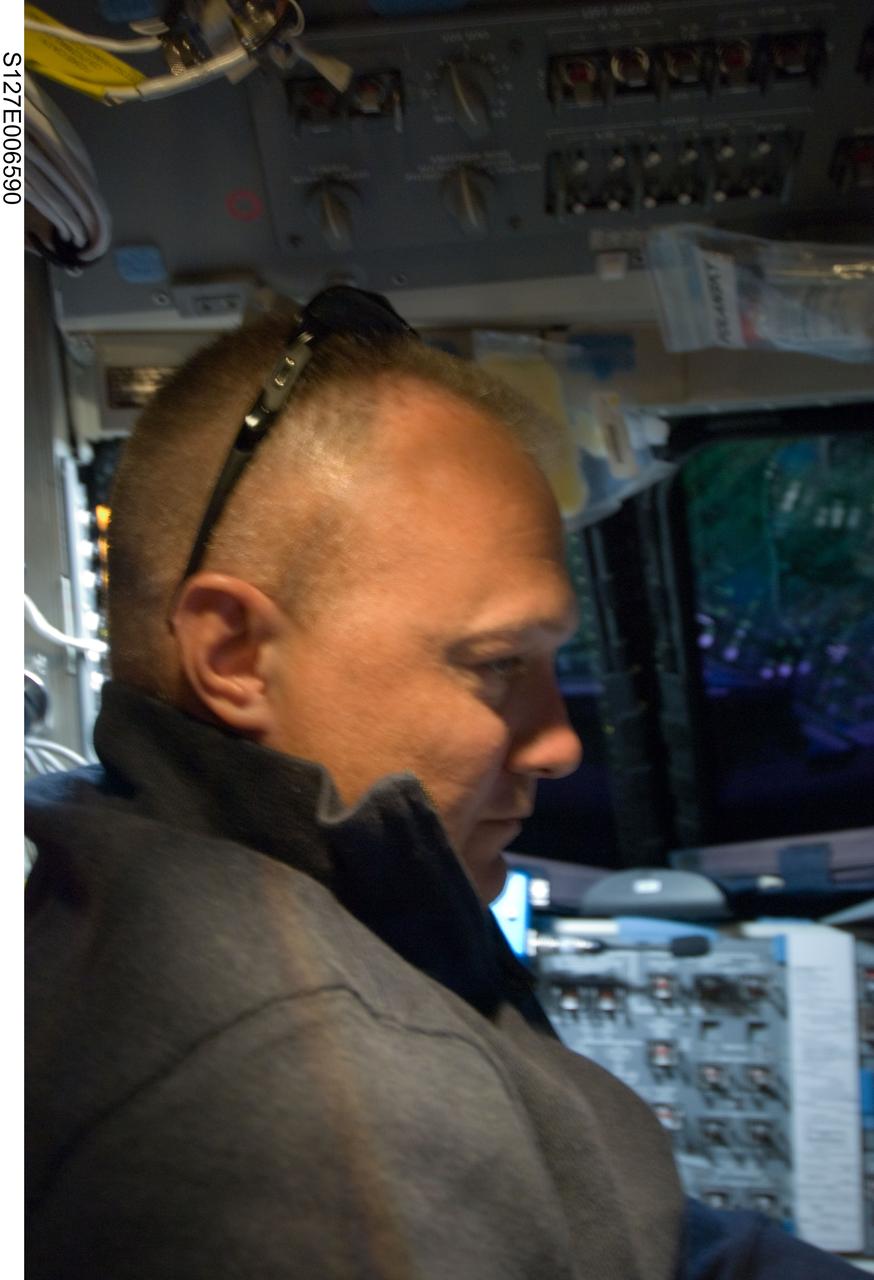 S127-E-006590 (17 July 2009) --- Astronaut Doug Hurley, STS-127 pilot, on flight deck duriong flight day 3.