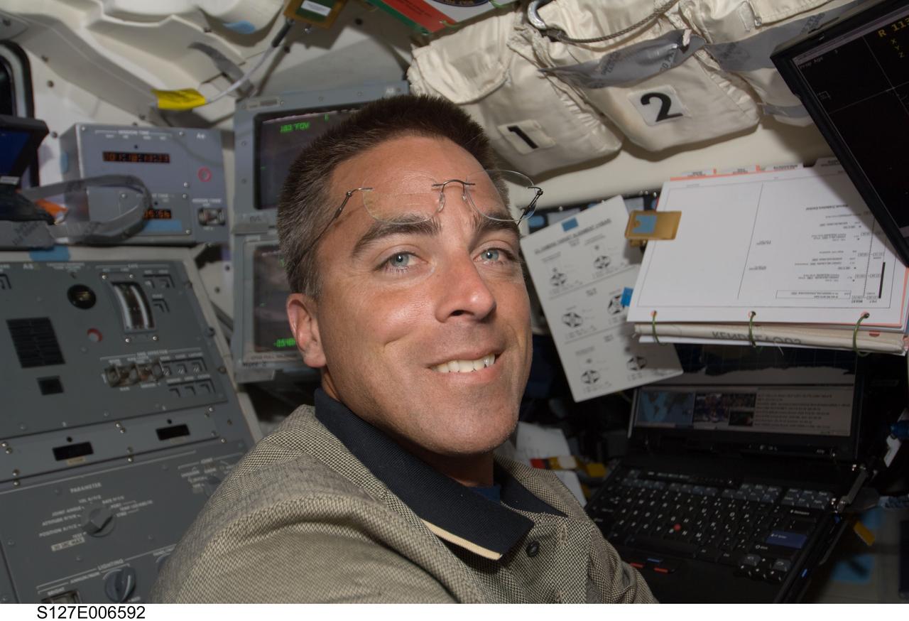 S127-E-006592 (17 July 2009) --- Astronaut Christopher Cassidy, STS-127 mission specialist, on Endeavour's flight deck during flight day three.