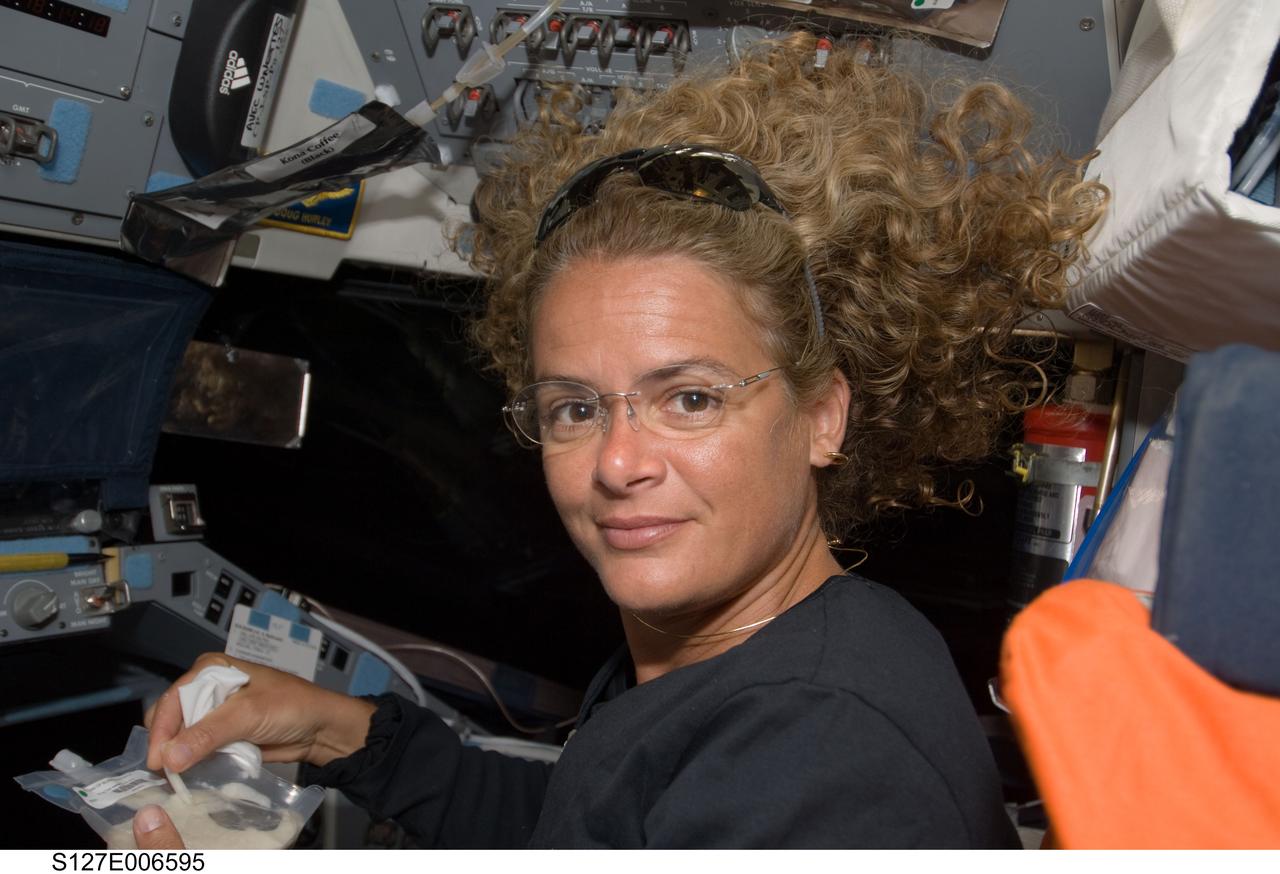 S127-E-006595 (17 July 2009) --- Astronaut Julie Payette, STS-127 mission specialist, on flight deck during flight day 3.