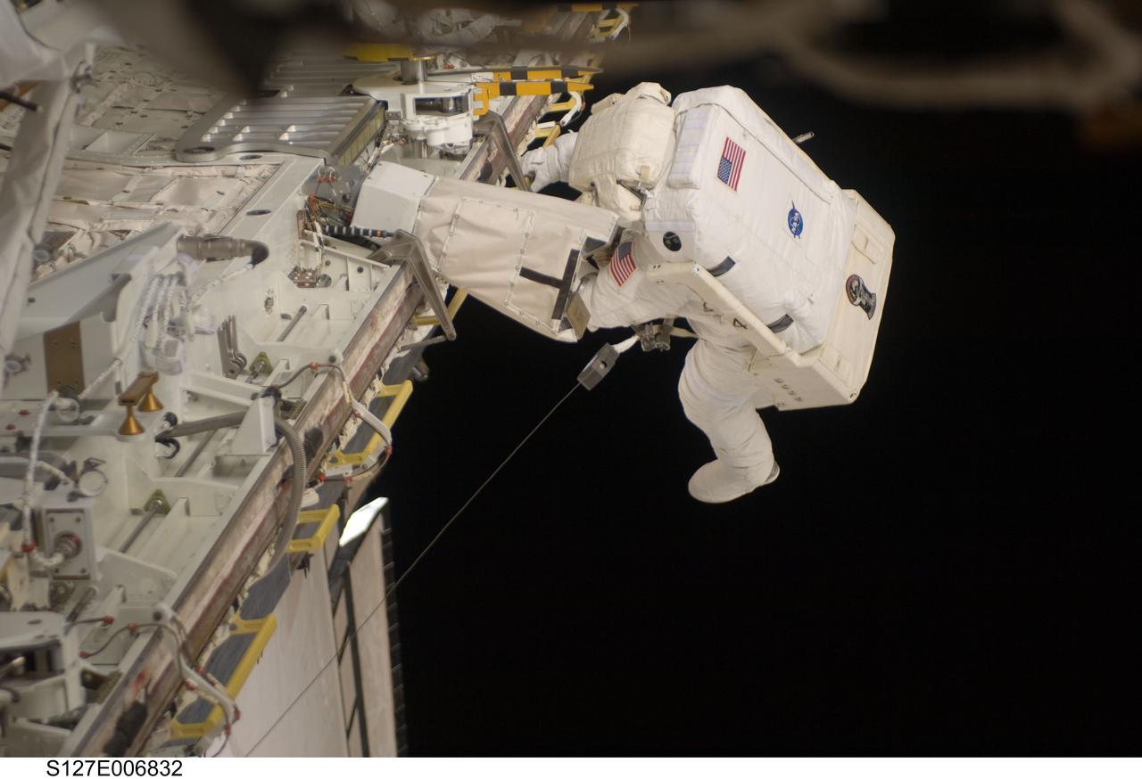 S127-E-006832 (18 July 2009) --- Astronaut Tim Kopra, mission specialist, is pictured at the edge of Endeavour's cargo bay during the first of five planned spacewalks to be performed on the International Space Station by the STS-127 crew. When the Endeavour crew returns to Earth, Kopra will stay onboard the space station to serve as flight engineer for ISS expedition duty.