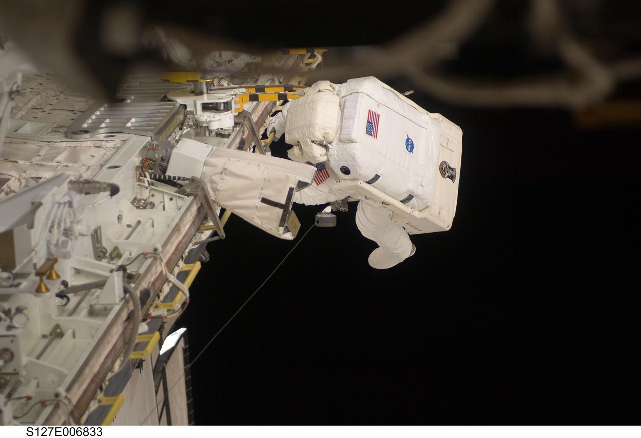 S127-E-006833 (18 July 2009) --- Astronaut Tim Kopra, mission specialist, is pictured at the edge of Endeavour's cargo bay during the first of five planned spacewalks to be performed on the International Space Station by the STS-127 crew. When the Endeavour crew returns to Earth, Kopra will stay onboard the space station to serve as flight engineer for ISS expedition duty.