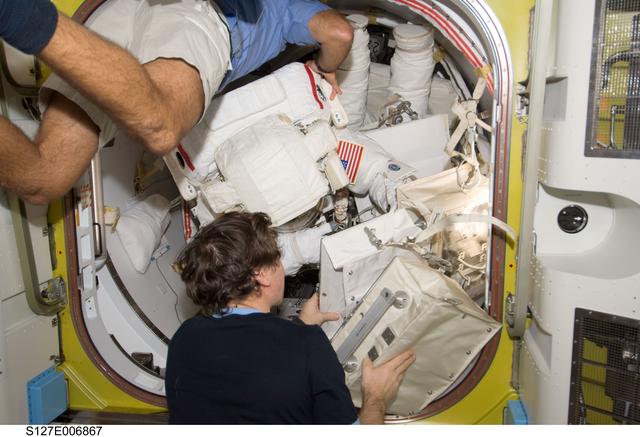 NASA image: Cassidy and Barratt assists Wolf and Kopra in the A/L during STS-127 / Expedition 20 Joint Operations
