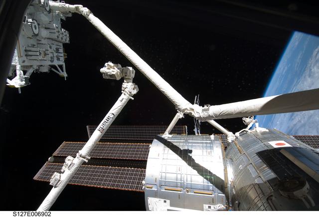 NASA image: SRMS handoff to the SSRMS during EVA-1 on STS-127 / Expedition 20 Joint Operations