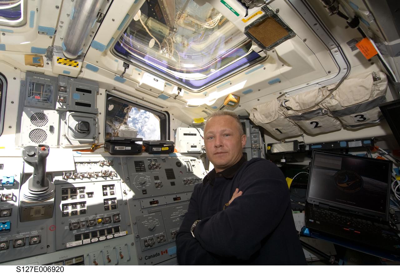 S127-E-006920 (19 July 2009) --- Astronaut Doug Hurley, pilot, is pictured at Endeavour's aft flight deck controls during flight day five operations with hardware on the International Space Station. The hardware moves will enable the second pair of spacewalkers to perform its spacewalk assignment on July 20.