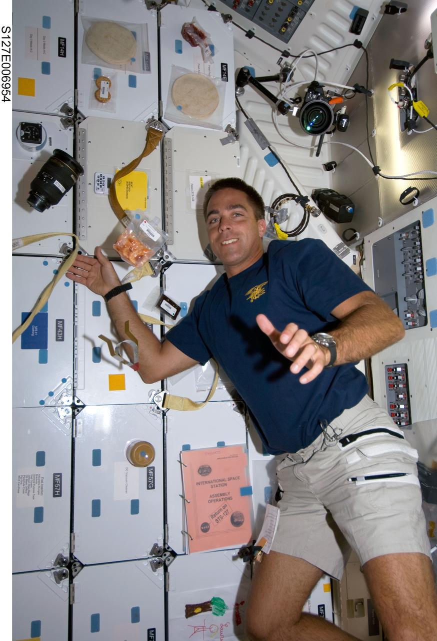 S127-E-006954 (19 July 2009) --- Astronaut Christopher Cassidy, STS-127 mission specialist, is pictured on the mid deck of the Space Shuttle Endeavour on a day between two days during which he is assigned support duty for space-walking crewmates. Meanwhile "upstairs" on the flight deck, crewmates are using remote controls and the Canadian-built remote manipulator system (RMS) arm to move the Integrated Cargo Carrier from Endeavour's payload bay.