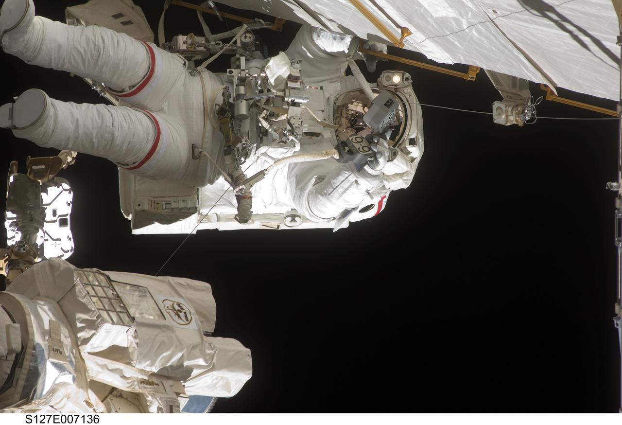 S127-E-007136 (20 July 2009) --- This is one of a series of digital still images showing astronaut Dave Wolf performing his second spacewalk and the Endeavour’s second also of the scheduled five overall in a little over a week’s time to continue work on the International Space Station.  Astronauts Wolf and Tom Marshburn (out of frame), both mission specialists,  successfully transferred a spare KU-band antenna to long-term storage on the space station, along with a backup coolant system pump module and a spare drive motor for the station's robot arm transporter. Installation of a television camera on the Japanese Exposed Facility experiment platform was deferred to a later spacewalk.
