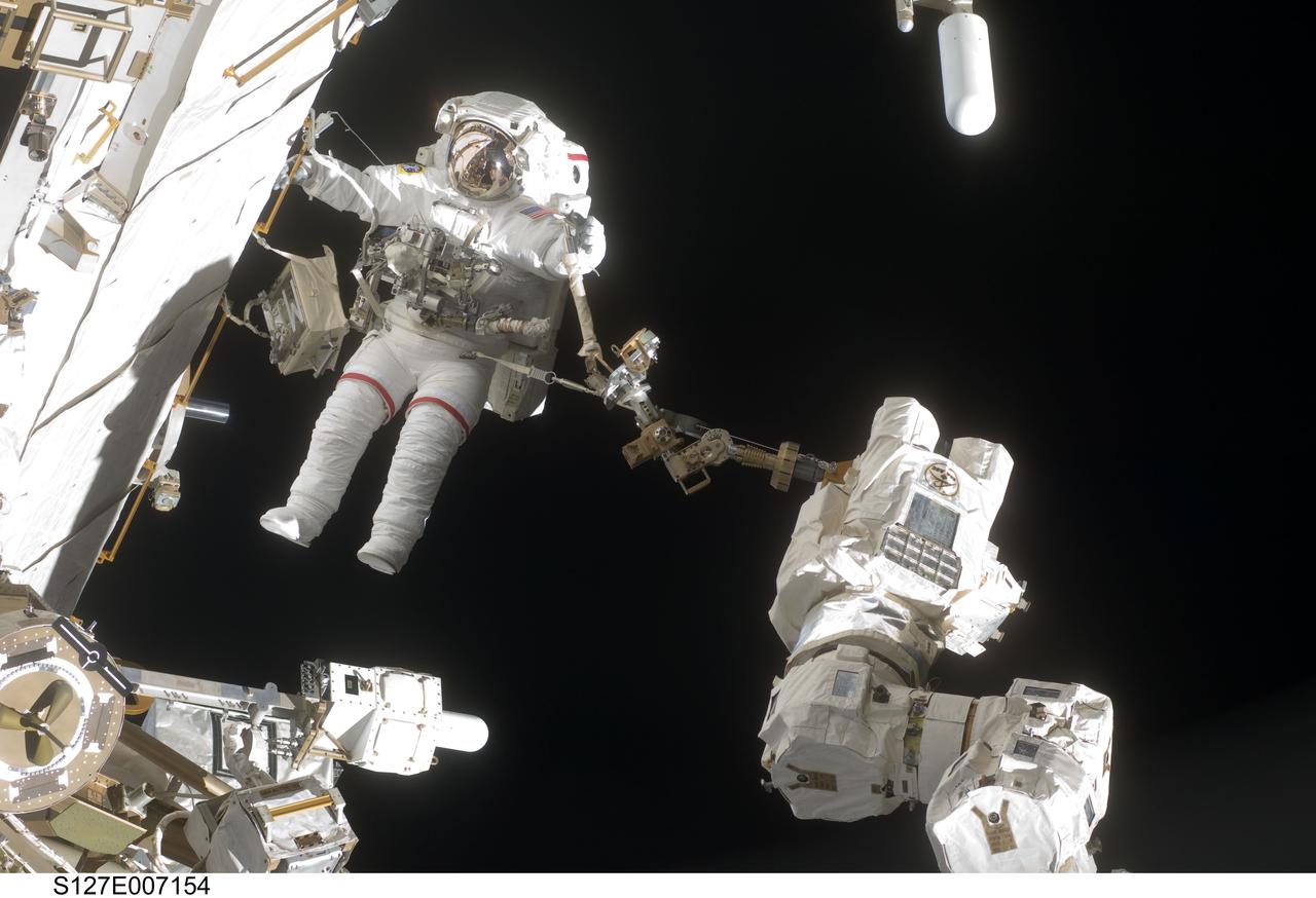 S127-E-007154 (20 July 2009) --- This is one of a series of digital still images showing astronaut Dave Wolf performing his second spacewalk and the Endeavour’s second also of the scheduled five overall in a little over a week’s time to continue work on the International Space Station.  Astronauts Wolf and Tom Marshburn (out of frame), both mission specialists,  successfully transferred a spare KU-band antenna to long-term storage on the space station, along with a backup coolant system pump module and a spare drive motor for the station's robot arm transporter. Installation of a television camera on the Japanese Exposed Facility experiment platform was deferred to a later spacewalk.